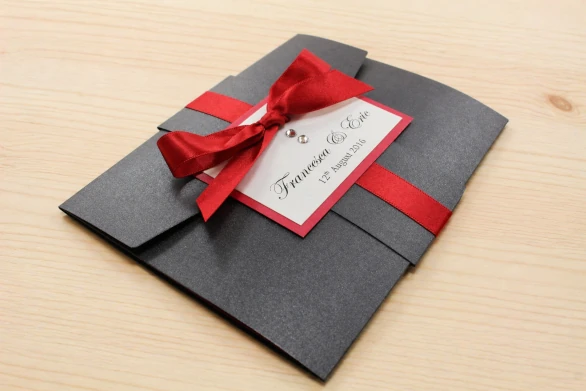Gothic Black and Berry Red Pocketfold Wedding invitation with a tied ribbon bow and sparkly crystals